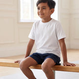 Boy in school PE lesson wearing Eco Outfitters organic cotton white t-shirt and PE shorts. 