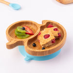 Bamboo duck-shaped weaning plate with fruit and cake.