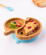 Bamboo duck-shaped weaning plate with fruit and cake.