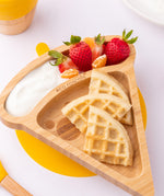 The Eco Rascals Pizza Bamboo Suction Plate with food inside, waffles are placed in the large triangle section and fruit and yoghurt are in the smaller curved section above. 