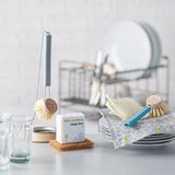 Ecoliving Dish Brush with Replaceable Heads pictured alongside other ecoliving kitchen products in a kitchen