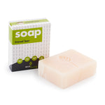 Ecoliving handmade solid travel soap bar on a white background next to its cardboard box