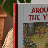Close up of teh luxury red cloth spine with gold embossed lettering on the Around The Year children's hardback book by Elsa Beskow. 
