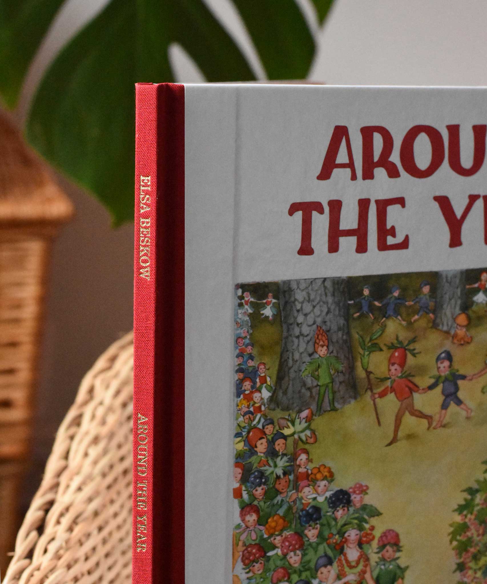 Close up of teh luxury red cloth spine with gold embossed lettering on the Around The Year children's hardback book by Elsa Beskow. 