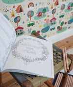 Inside page from the The World of Elsa Beskow: A Vintage Colouring Book placed on a stool in the Babipur playroom. Black and white line art coloring page. 