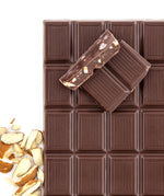 almond chocolate broken into pieces with almonds next to it