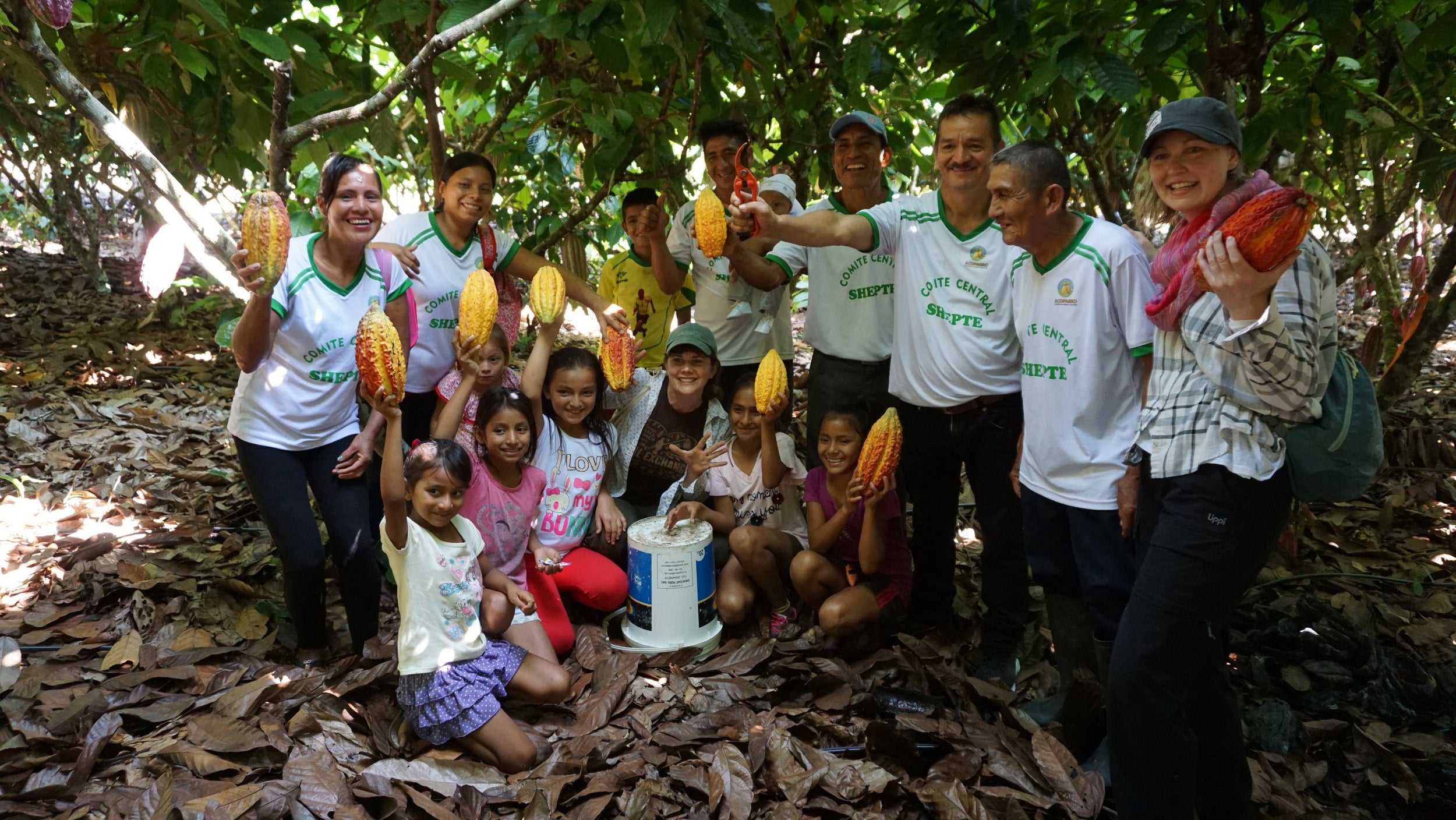 Cacao bean farmers posing with the beans.