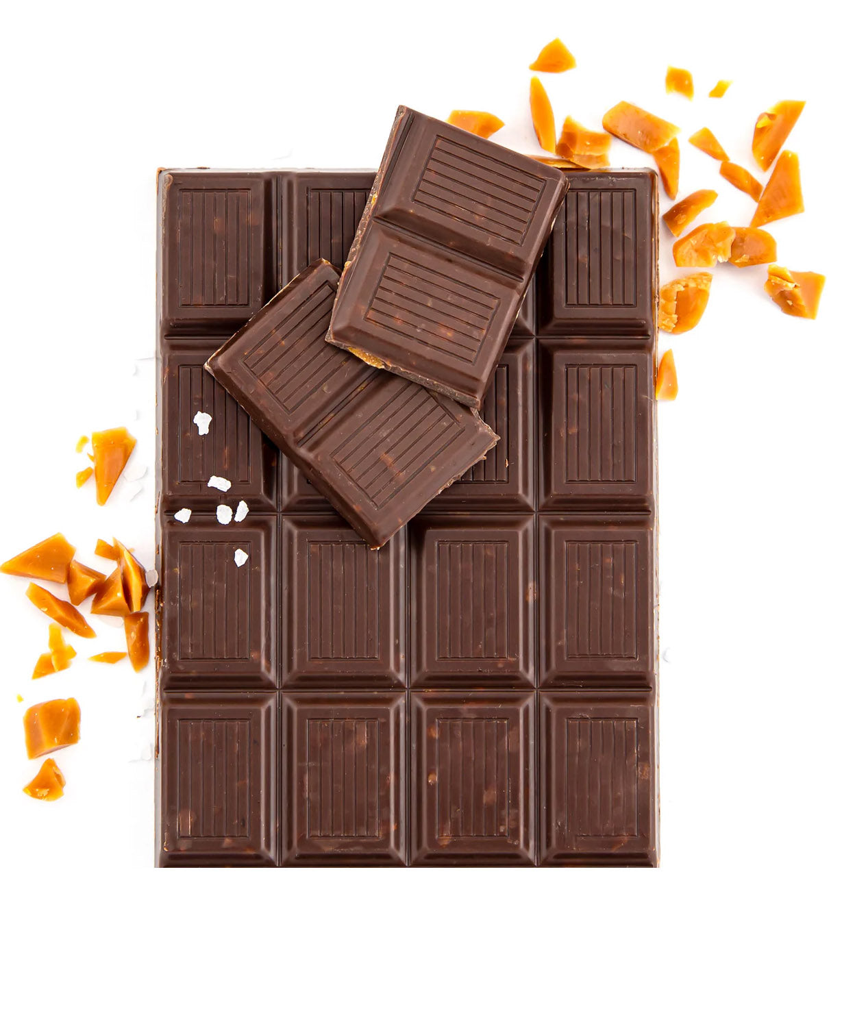 Bar of caramel chocolate broken into pieces with bits of carmel around