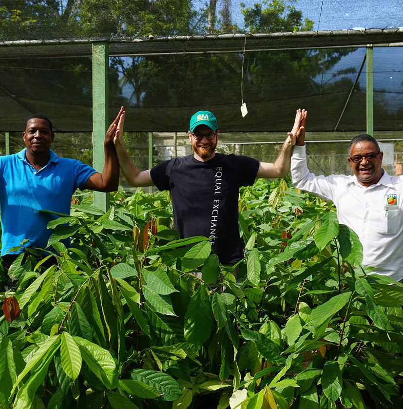 equal exchange worker holding hands with farmers