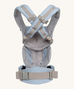 The back of the Ergobaby Omni 360 Cool Air Mesh Baby Carrier in a light blue chambray colour showing the shoulder strap detail 