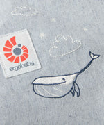 Cute whale and cloud embroidery on the Ergobaby denim dream toy carrier