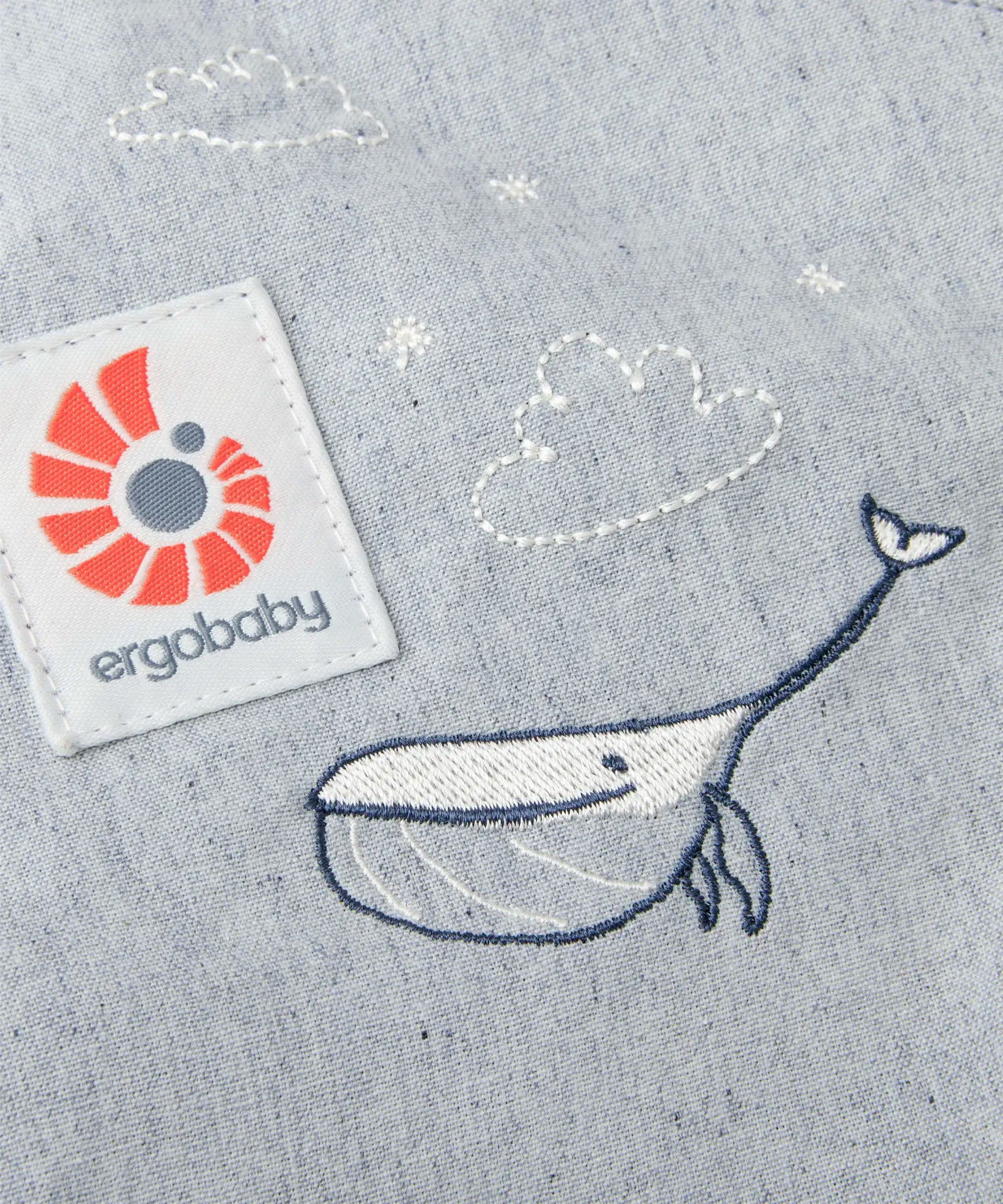 Cute whale and cloud embroidery on the Ergobaby denim dream toy carrier