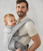 Ergobaby omni deluxe baby carrier  SoftTouch cotton in pearl grey. Baby worn in carrier facing the parent.