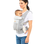Woman with straight brown hair and a white t-shirt wearing her baby in the Ergobaby Adapt  SoftFlex™ Mesh Baby Carrier in Pearl Grey. Front view, white background. 