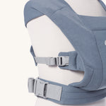 Close up of the buckles on the Ergobaby Embrace Soft Knit Newborn Baby Carrier in Oxford Blue. Side view on a mannequin.