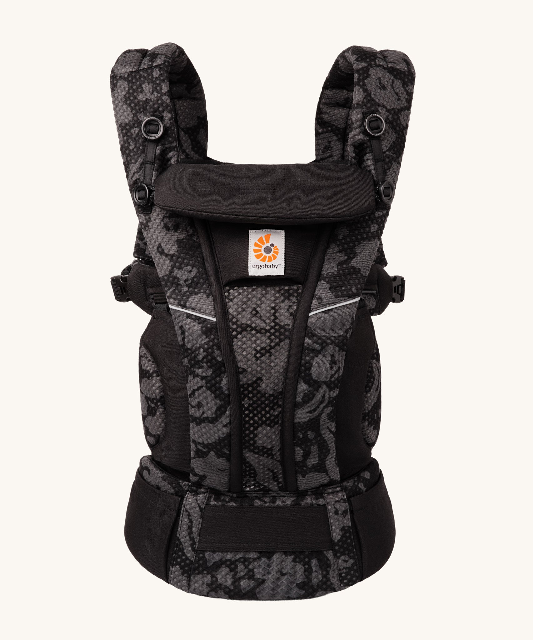 Ergobaby Omni Breeze Baby Carrier in omni breeze. A black coloured carrier with an abstract floral pattern. 