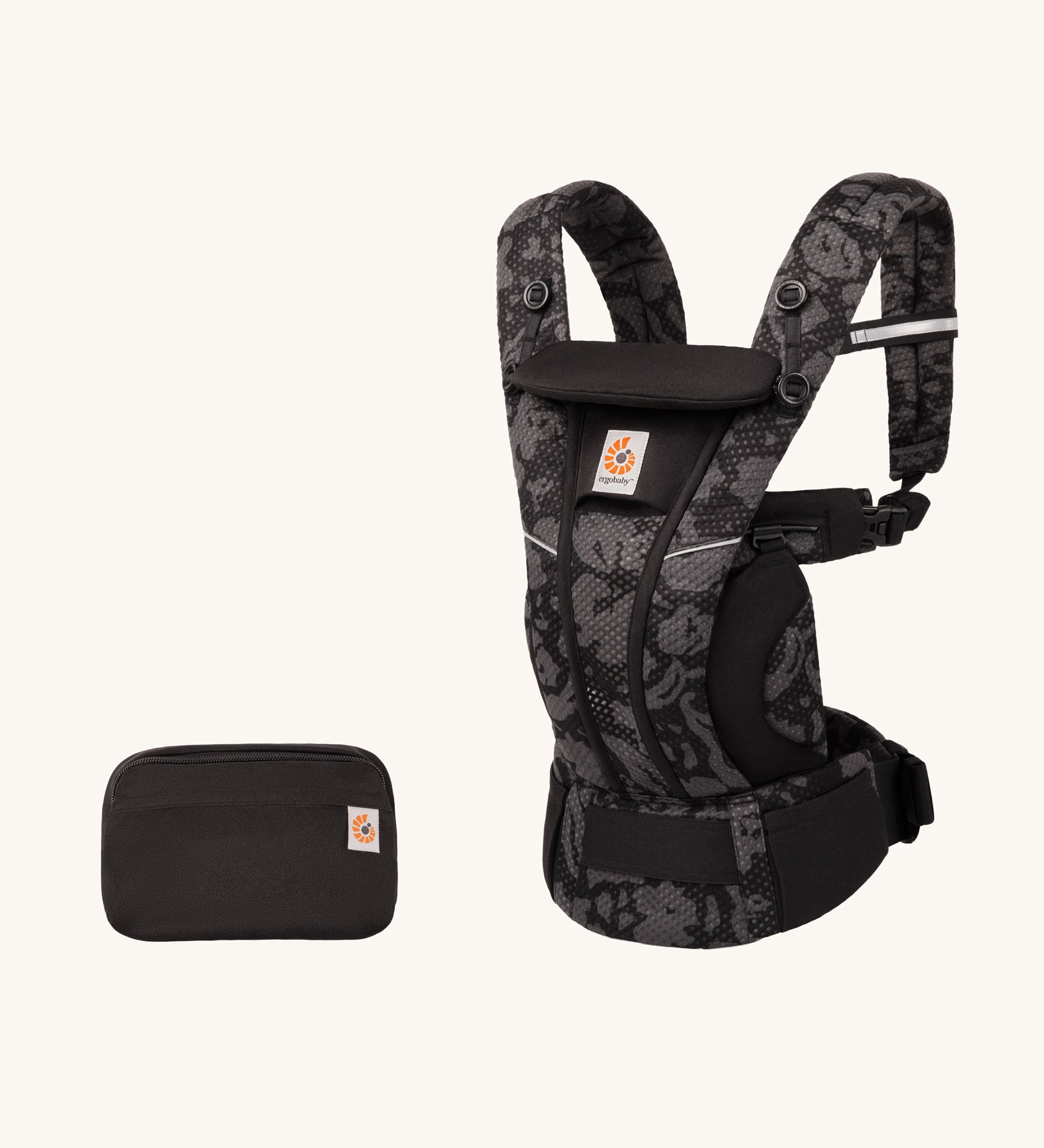 Ergobaby Omni Breeze Baby Carrier in omni breeze with a storage pouch. A black coloured carrier with an abstract floral pattern. 
