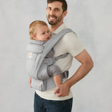 Ergobaby omni deluxe baby carrier  SoftTouch cotton in pearl grey. Baby worn in carrier facing the parent.