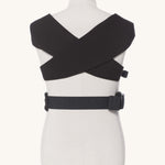 Ergobaby Embrace Soft Knit Newborn Baby Carrier in Pure Black. Back view showing the cross over straps on a mannequin.
