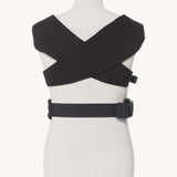 Ergobaby Embrace Soft Knit Newborn Baby Carrier in Pure Black. Back view showing the cross over straps on a mannequin.