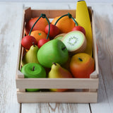 Erzi big wooden toy crate for fruit filled with wooden fruit play food including cherries, kiwis, bananas, apples, lemons and oranges.