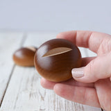 Erzi bread roll wooden play food in an adult's hand. 