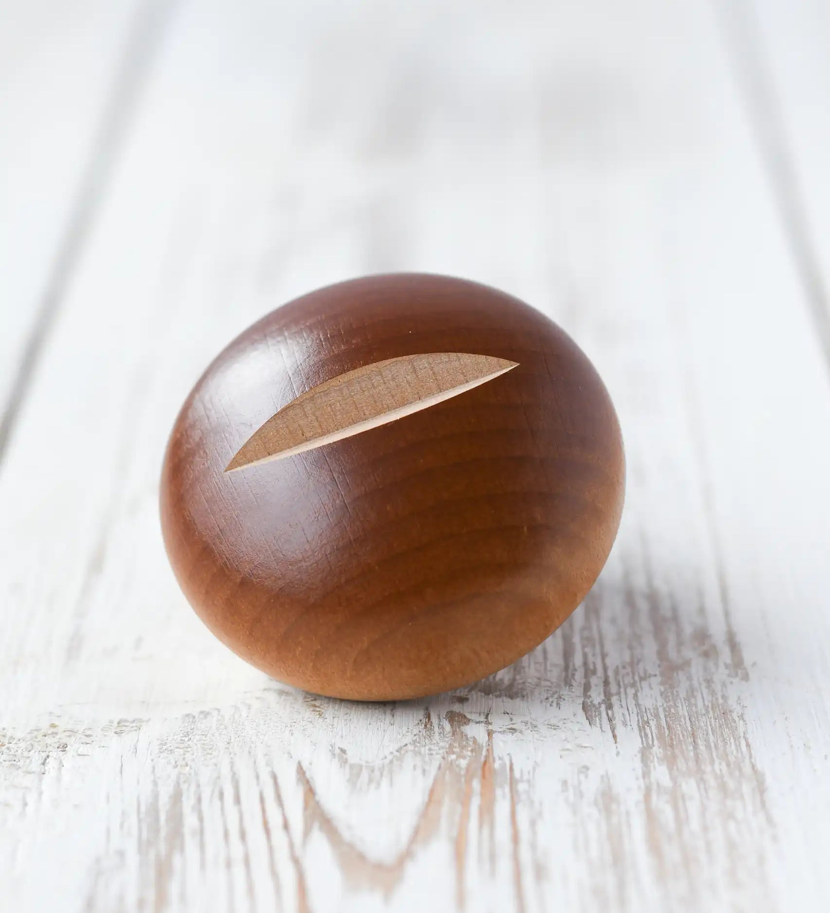 Erzi bread roll wooden play food placed on a wooden surface. 