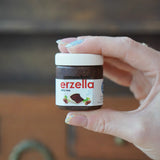 Erzi Erzella chocolate spread wooden play food shown in an adult's hand.