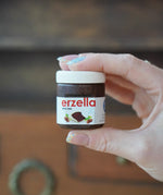Erzi Erzella chocolate spread wooden play food shown in an adult's hand.