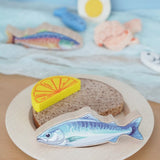 Pieces from the Erzi fish assortment wooden food play set used to create a meal in the  Babipur playroom.