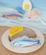 Pieces from the Erzi fish assortment wooden food play set used to create a meal in the  Babipur playroom.