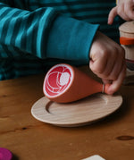Erzi Gammon joint Wooden Play Food placed on a wooden toy place, child's hand picking up the meat. 