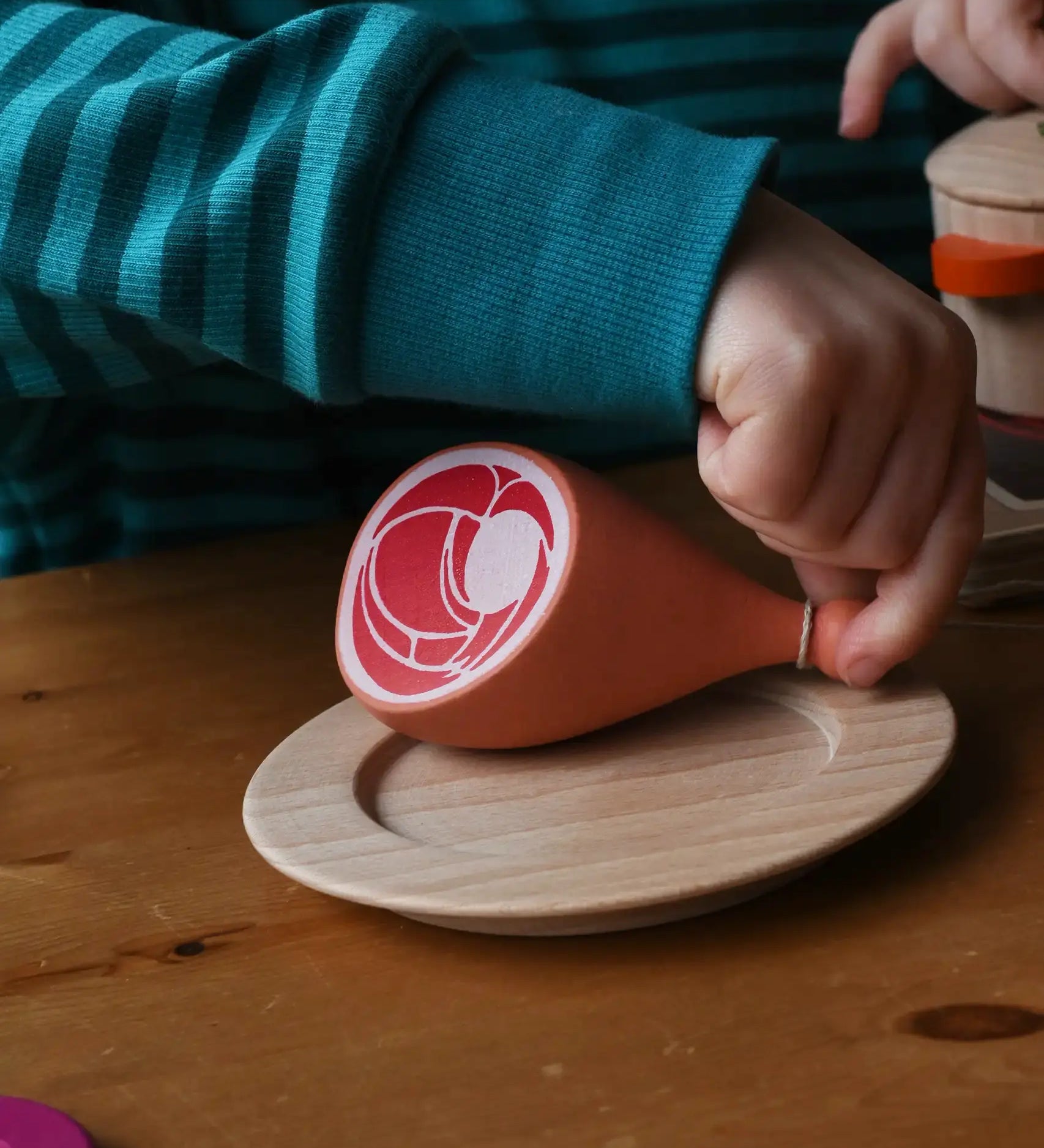 Erzi Gammon joint Wooden Play Food placed on a wooden toy place, child's hand picking up the meat. 