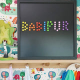 Erzi pixelino magnetic blocks spelling Babipur on a Grimm's black magnetic board