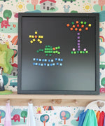 A crocodile, sun and tree on a Grimm's magnetic board made from Erzi pixelino magnetic blocks 