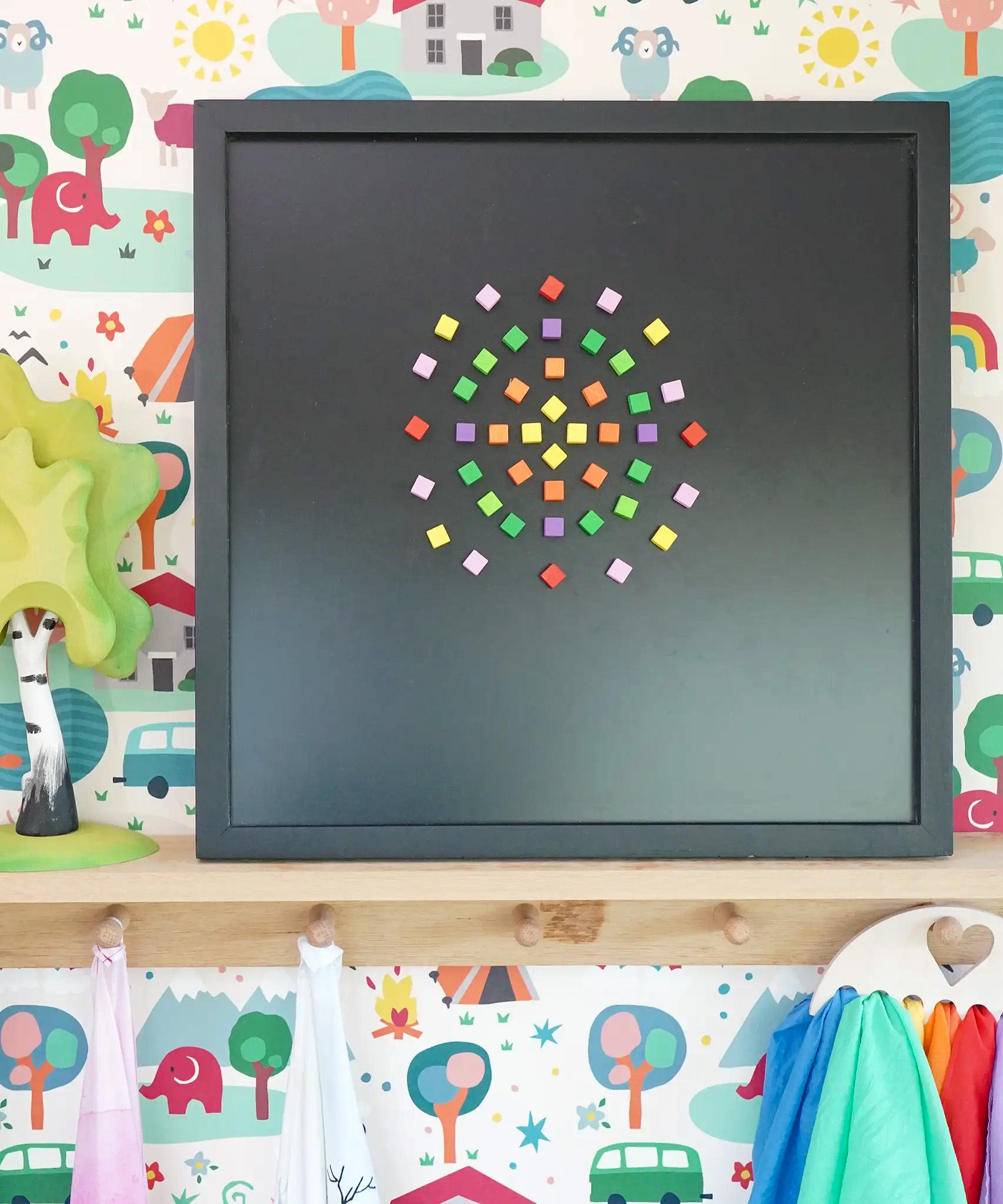 A mandala pattern on a black Grimms magnetic board using Erzi pixelino magnetic blocks 