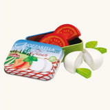 Erzi mozzarella and tomato wooden play food set shown with the lid taken off the metal storage tin.