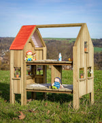 Erzi pine wooden outdoor dollhouse play set with dolls and play food on the two floors and small flower pots on the windowsills. 2 sided, 2 level play house for toys. 