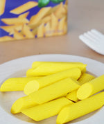 Erzi wooden play food penne pasta placed on a plate in the Babipur playroom.