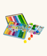 Eri Pixelinó magnetic toy set in a colorful metal tin, shown open with rainbow grid tiles, game cards, and small multicolored cube blocks.