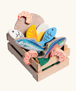 Erzi fish assortment wooden food play set in a wooden crate. Set contains 5 types of fish, 3 shrimps, bread, half and egg and lemon slice.
