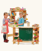 Children playing shop with the Erzi waxed birch plywood wooden premium extra large play shop. The shelving and crated are filled with wooden play food.