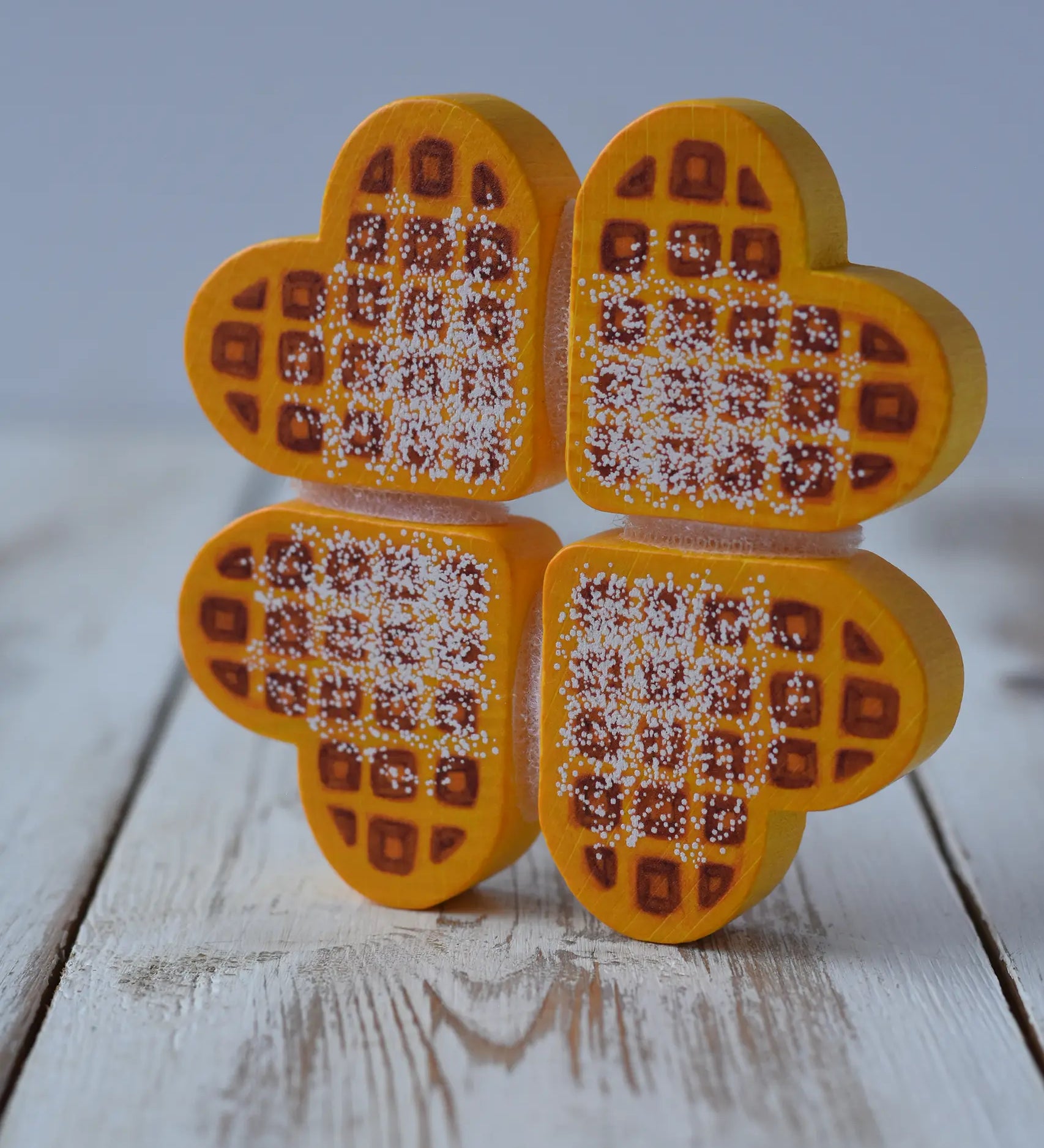Erzi Waffles To Cut Wooden Play Food placed upright on a wooden surface.