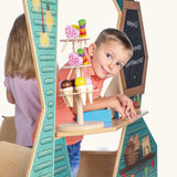 Child standing at the serving hatch counter of the Erzi wooden play foodtruck food vendor vehicle.