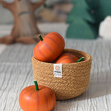 Erzi pumkins placed in a natural jute respiin basket. 