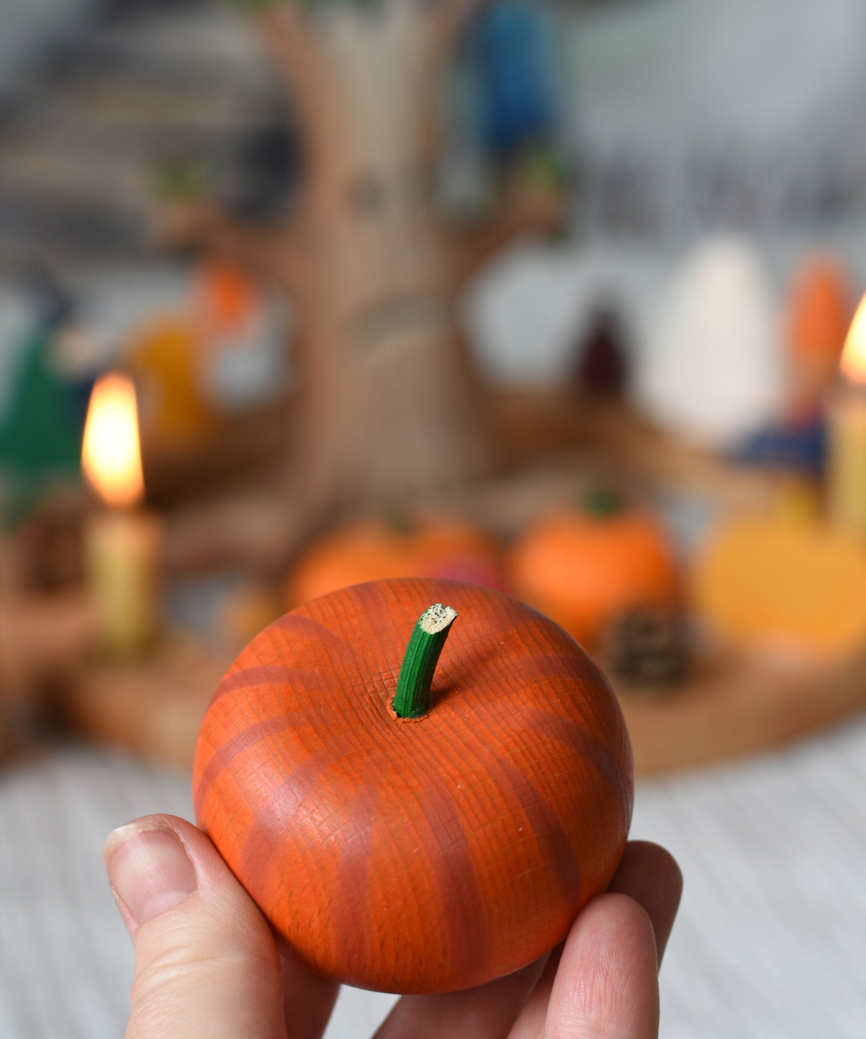 An Erzi pumpkin shown in an adult's hand for scale. 