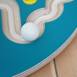 A close up of an Erzi 30mm marble on a trackboard. 