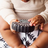 A child holding the amonite bath toy from the Etta Loves sensory bath toy set