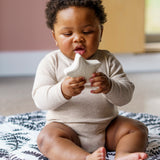 A child playing with  the starfish bath toy from the Etta Loves sensory bath toy set