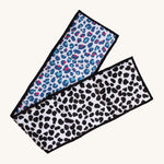 Etta Loves Organic Cotton Reversible Baby Sensory Strip - Animal Print, with a black, spotted Dalmatian print on one side, and a colourful red and light blue Leopard print on the other